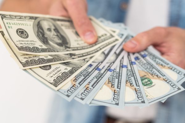 American dollars in a women hands. High quality photo